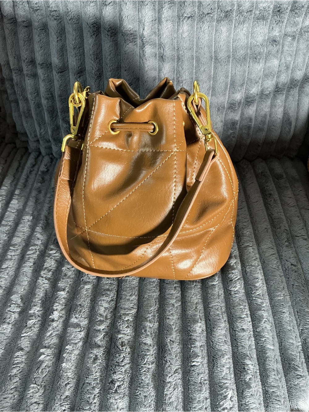 Classic Tan Leather Drawstring Bucket Bag with Gold Hardware